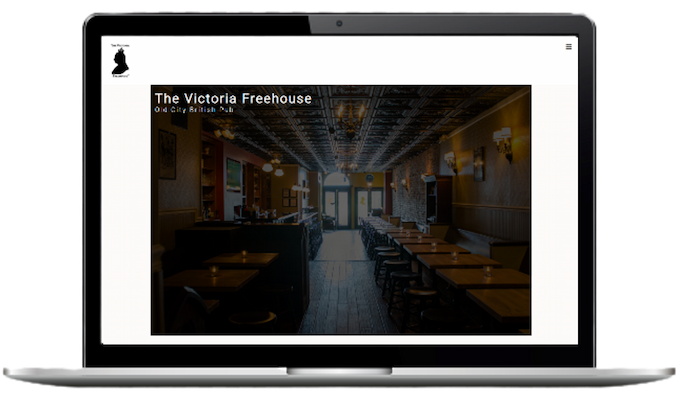 A picture of a laptop with the background of Victoria Freehouse's Homepage